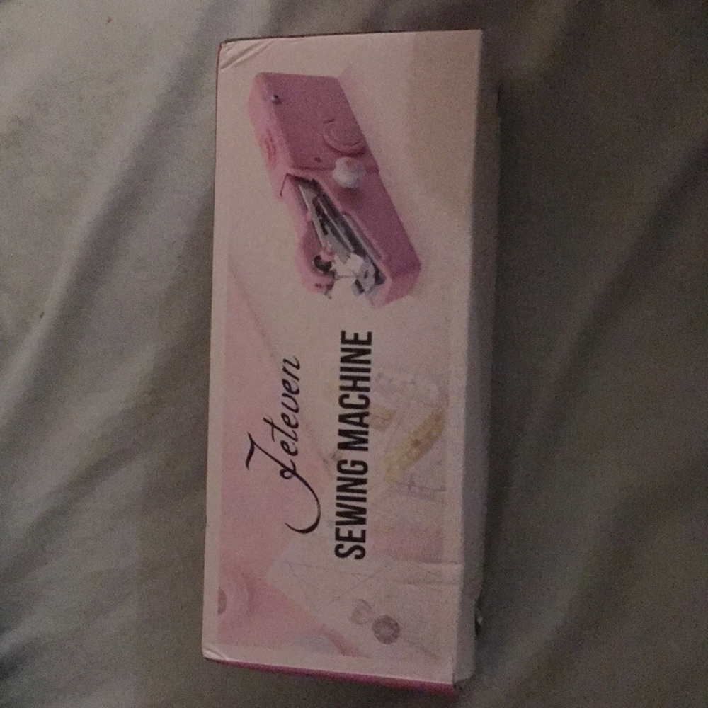 Hand held sewing machine